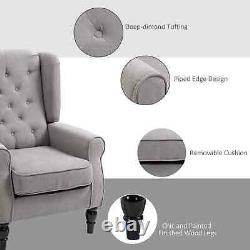 Fauteuil d'appoint simple de style rétro avec accoudoirs et dossier haut, siège capitonné, gris.